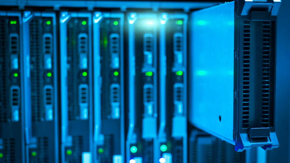 Illuminated server racks in a data centre aisle