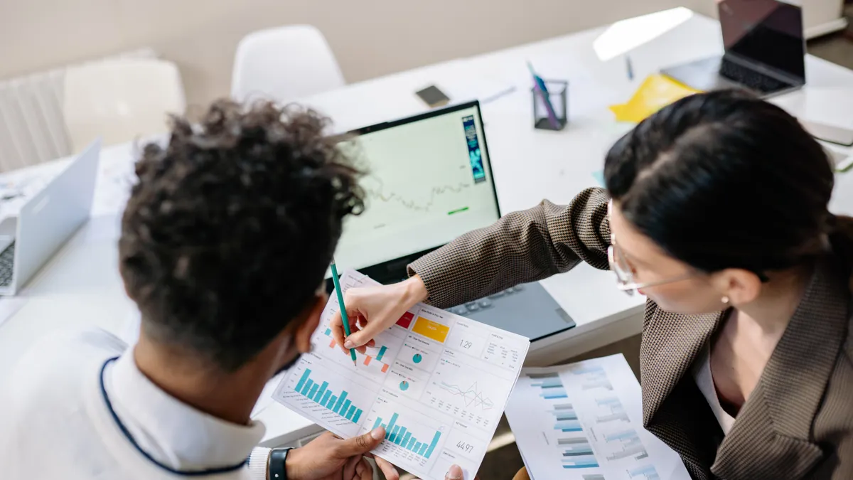 Marketing team reviewing campaign performance reports together