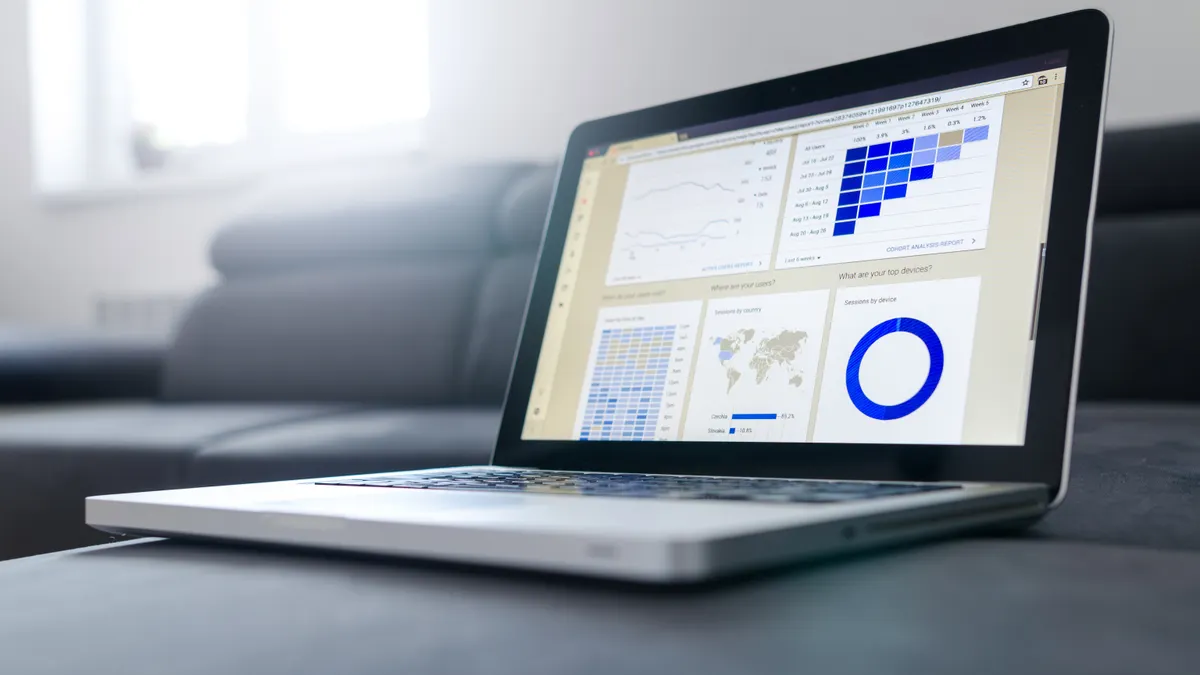 Laptop screen showing a web application dashboard with charts