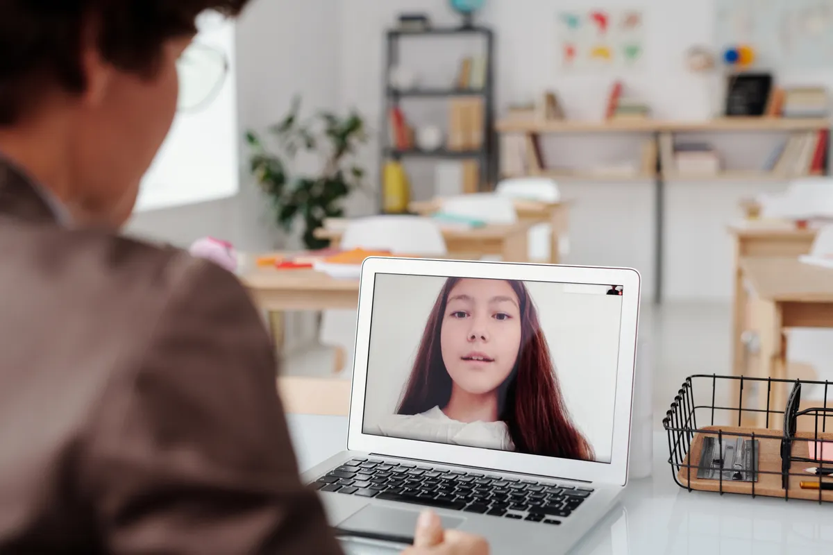 Student attending an online class on a laptop