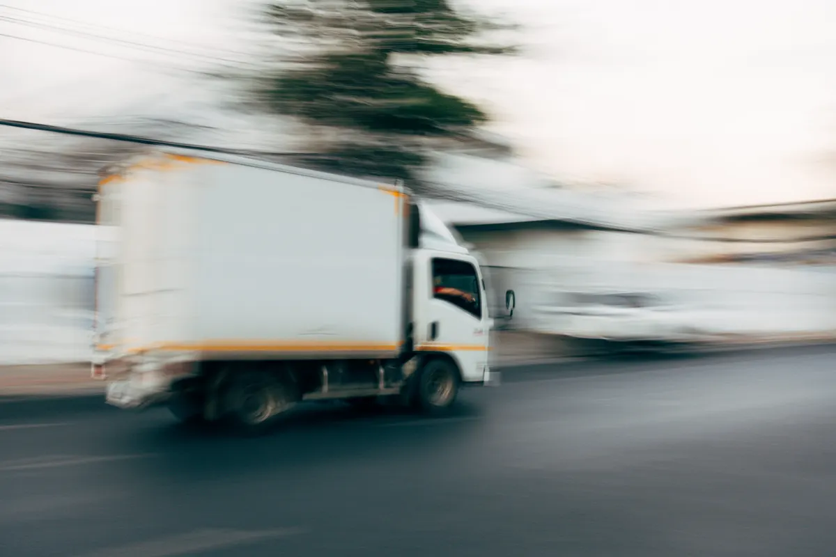 Delivery truck in motion on an open road