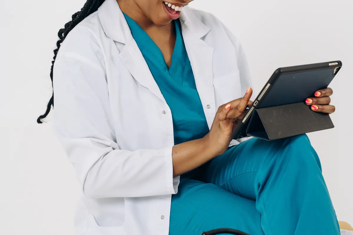 Clinicians reviewing patient information on a tablet