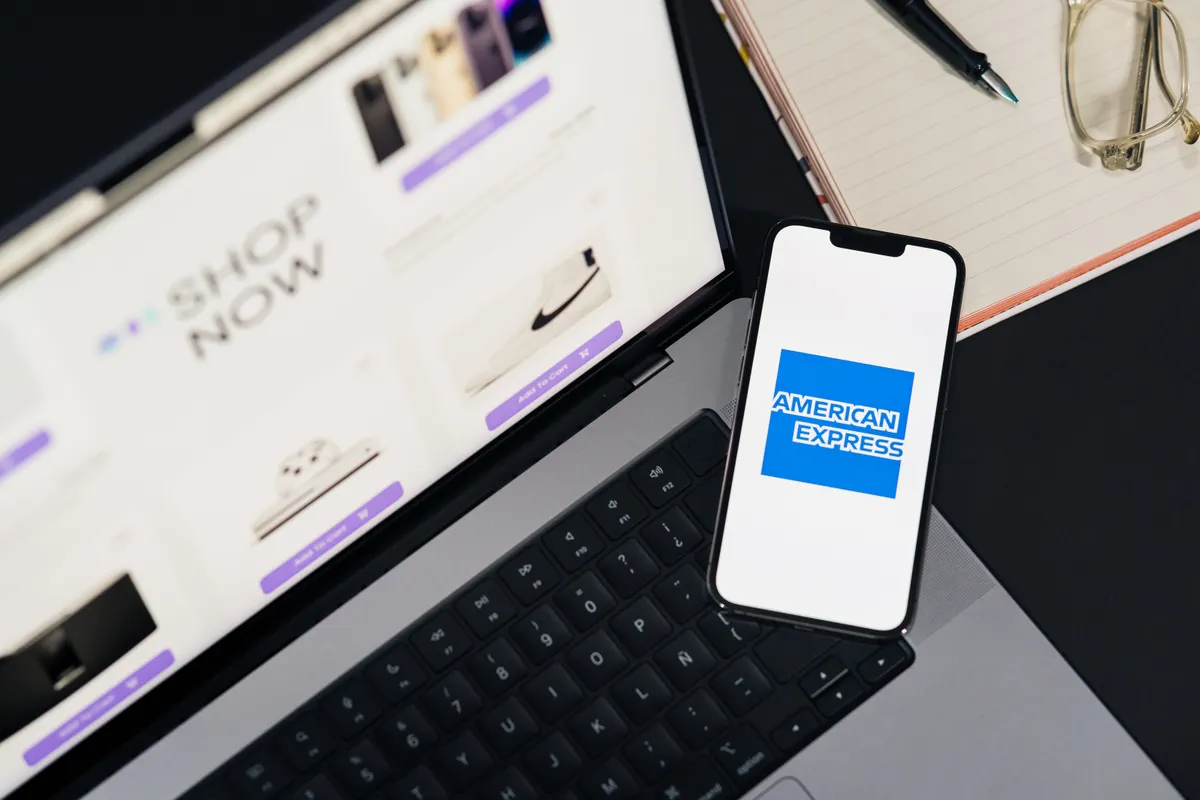 Online storefront shown on a smartphone beside a laptop